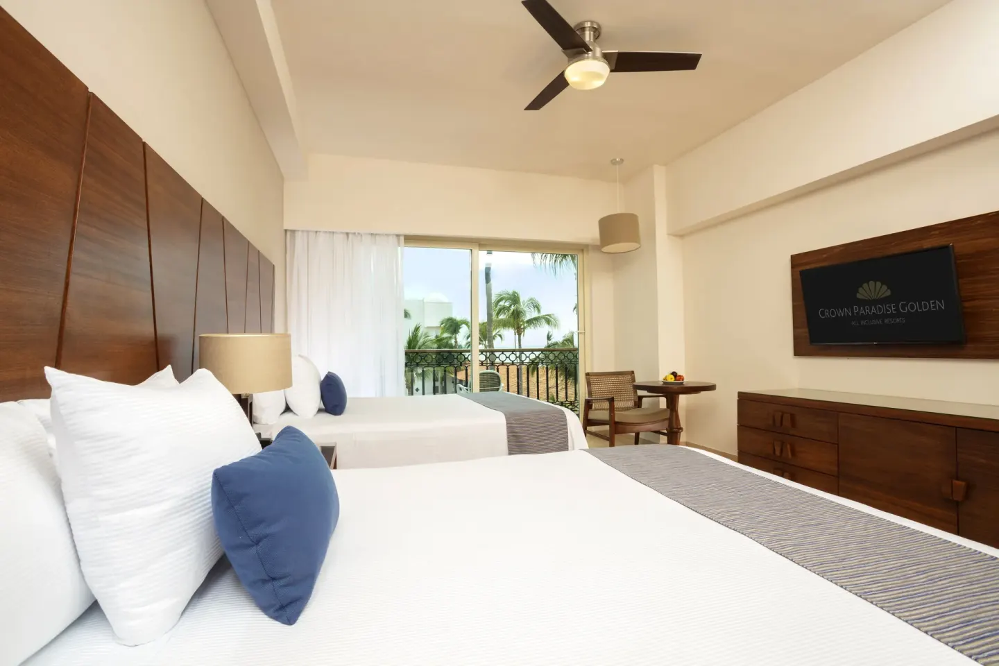 Deluxe Room with two beds and balcony doors at Crown Paradise Golden Resort.