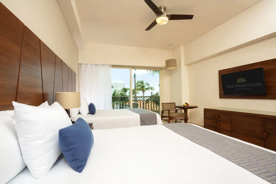 Deluxe Room with two beds and balcony doors at Crown Paradise Golden Resort.