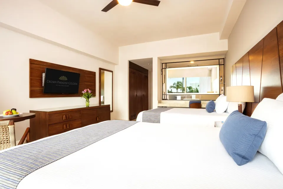 Deluxe Room with two beds, wood furniture, and vanity at Crown Paradise Golden Resort.