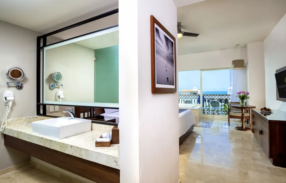 Suite Crown Paradise Golden Resort room vanity, bed area, and balcony at Crown Paradise Golden Resort.