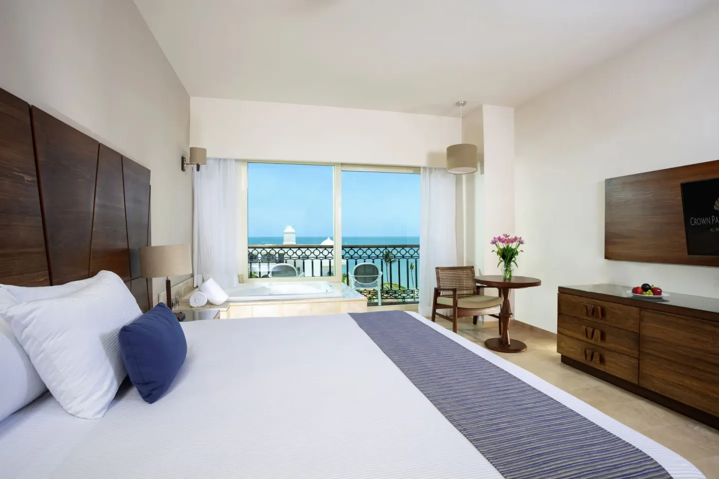 Suite Crown Paradise Golden Resort king bed, indoor tub, and ocean balcony at Crown Paradise Golden Resort.