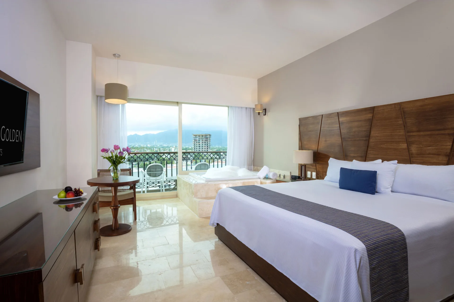 Suite Crown room with king bed, whirlpool tub, and balcony view at Crown Paradise Golden Resort.