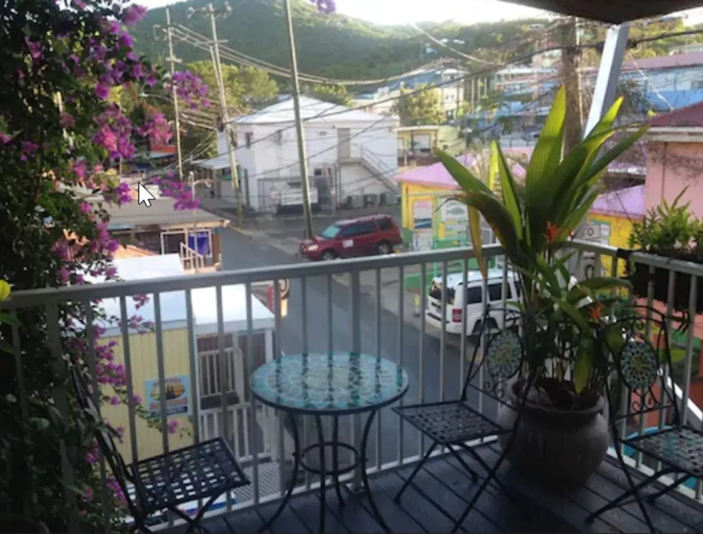 Balcony table and chairs overlooking a Cruz Bay Boutique Hotel street at Cruz Bay Boutique Hotel.