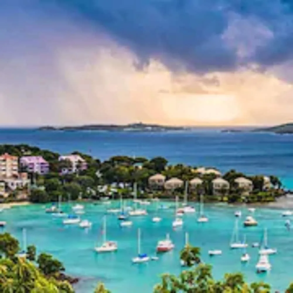 Harbor view with anchored boats and blue water near Cruz Bay Boutique Hotel.