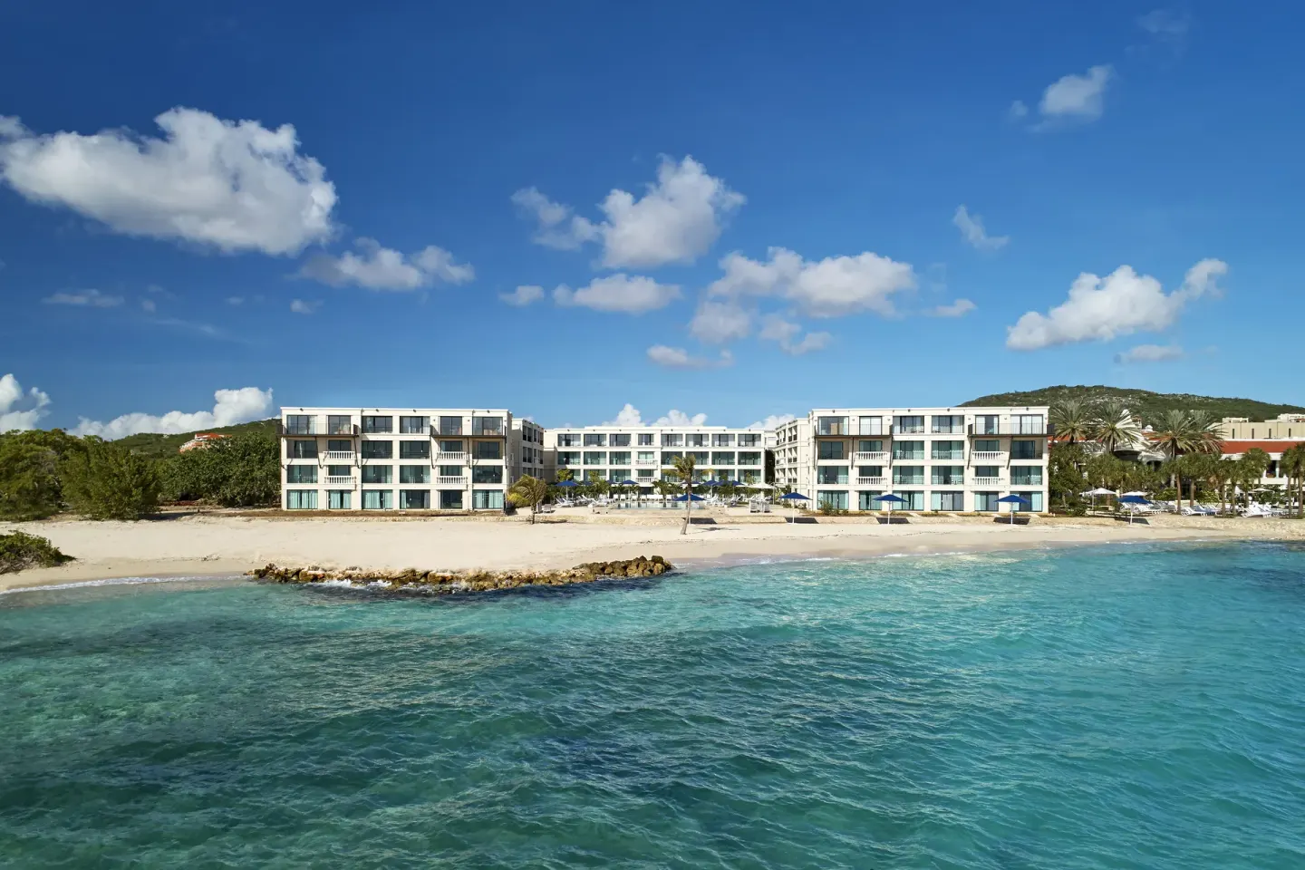 Beachfront resort buildings and turquoise water at Curacao Marriott Beach Resort.