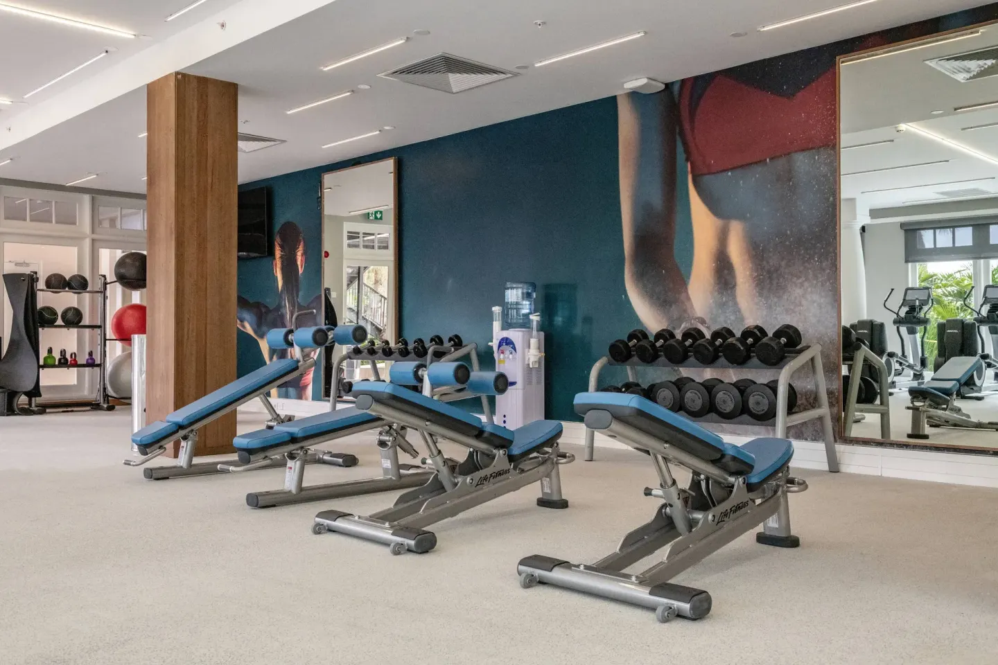 Weight benches and dumbbells in the fitness center at Curacao Marriott Beach Resort.