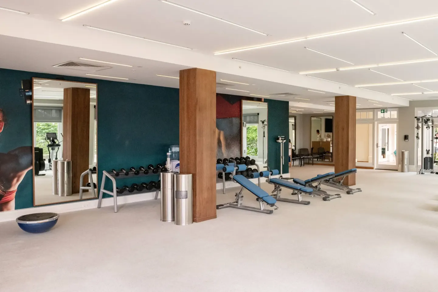 Spacious fitness center with benches and mirrors at Curacao Marriott Beach Resort.