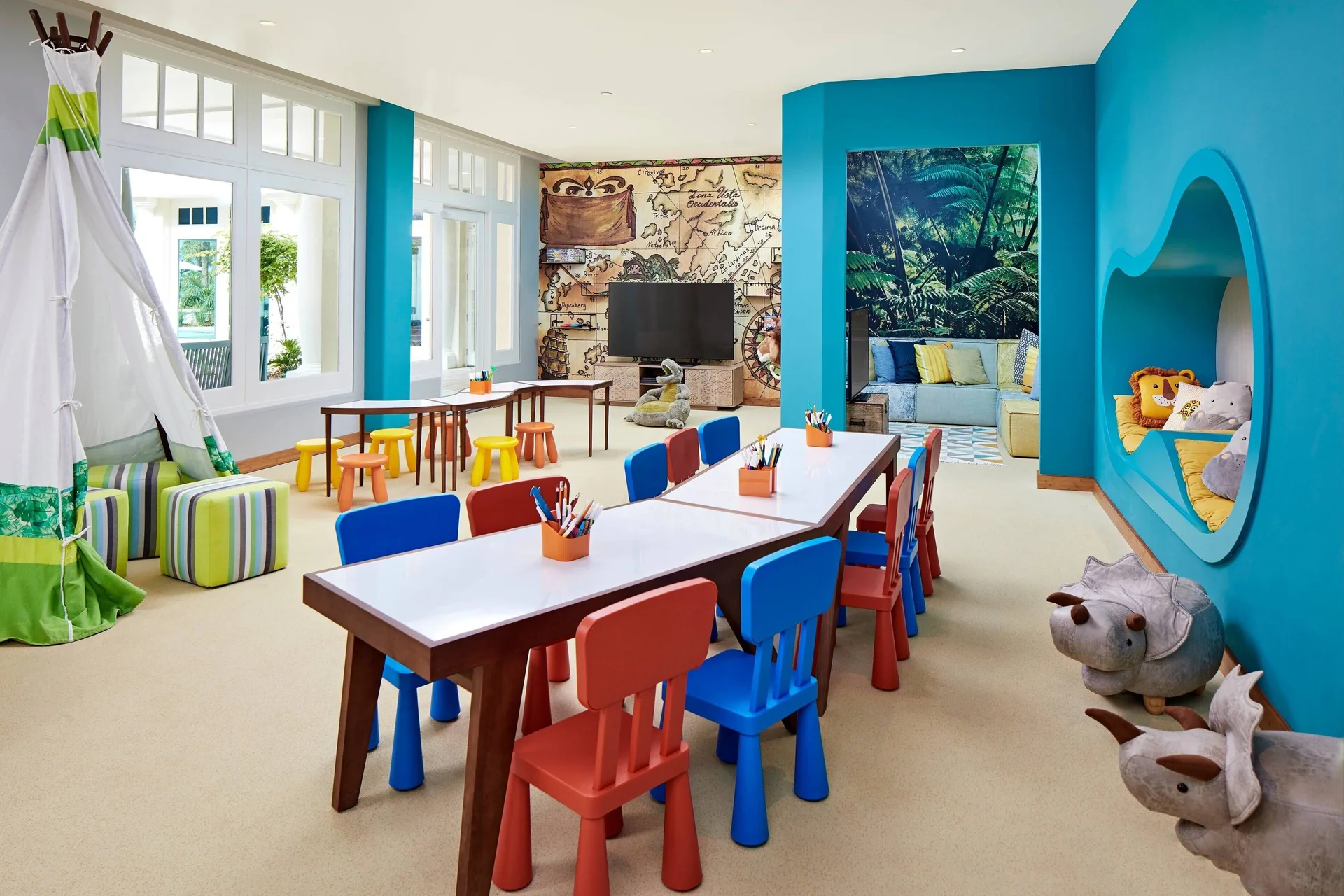 Colorful kids club playroom with small chairs and art tables at Curacao Marriott Beach Resort.