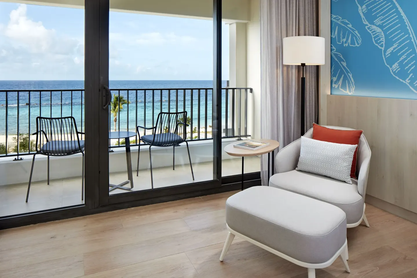 Ocean-view guest room sitting area and balcony at Curacao Marriott Beach Resort.