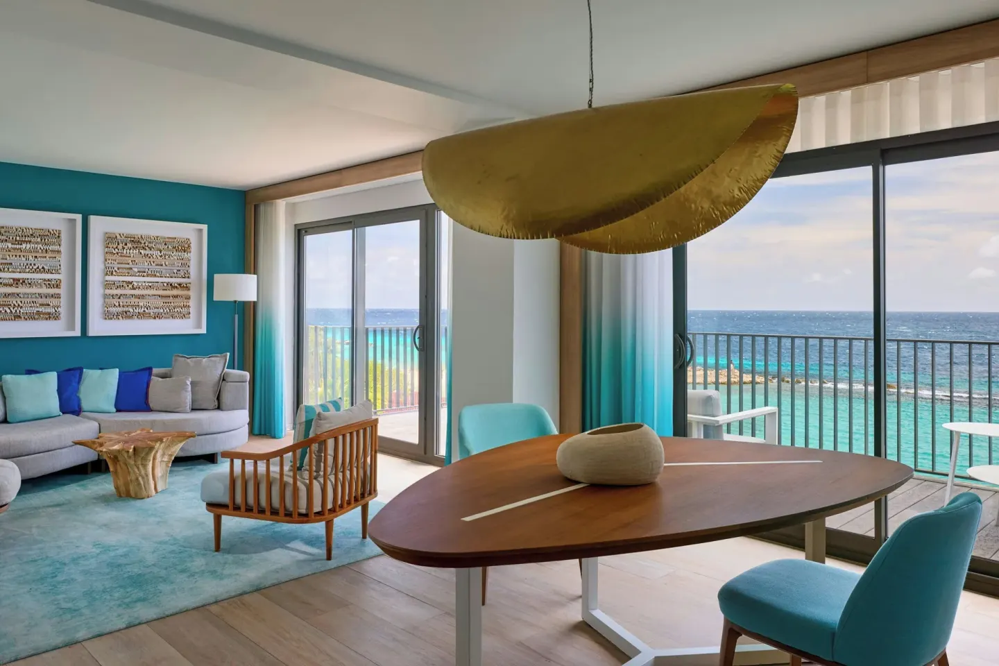 Suite dining table and lounge area overlooking the ocean at Curacao Marriott Beach Resort.