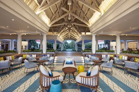 Open-air lobby seating under a vaulted wood ceiling at Curacao Marriott Beach Resort.