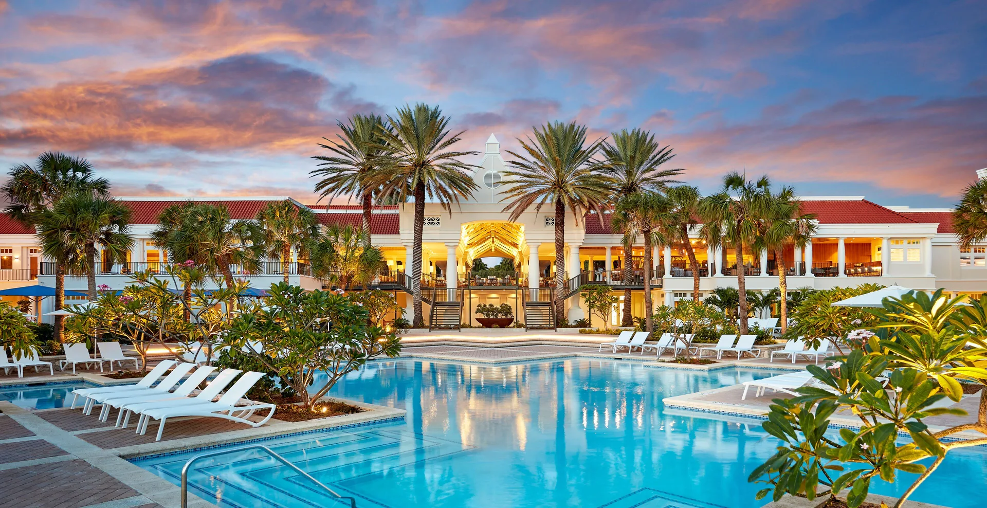 Twilight pool and palm-lined resort building at Curacao Marriott Beach Resort.