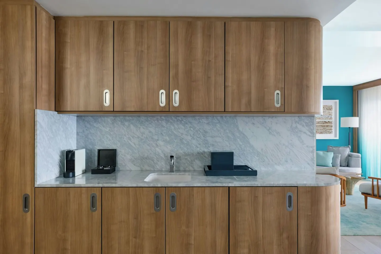 Suite wet bar with wood cabinetry and marble backsplash at Curacao Marriott Beach Resort.