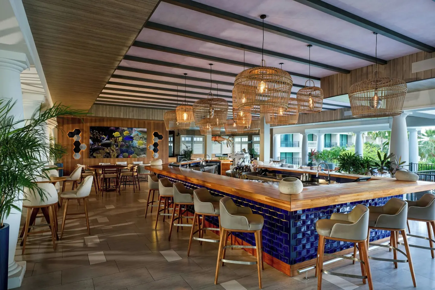 Blue-tiled bar with woven pendant lights at Curacao Marriott Beach Resort.