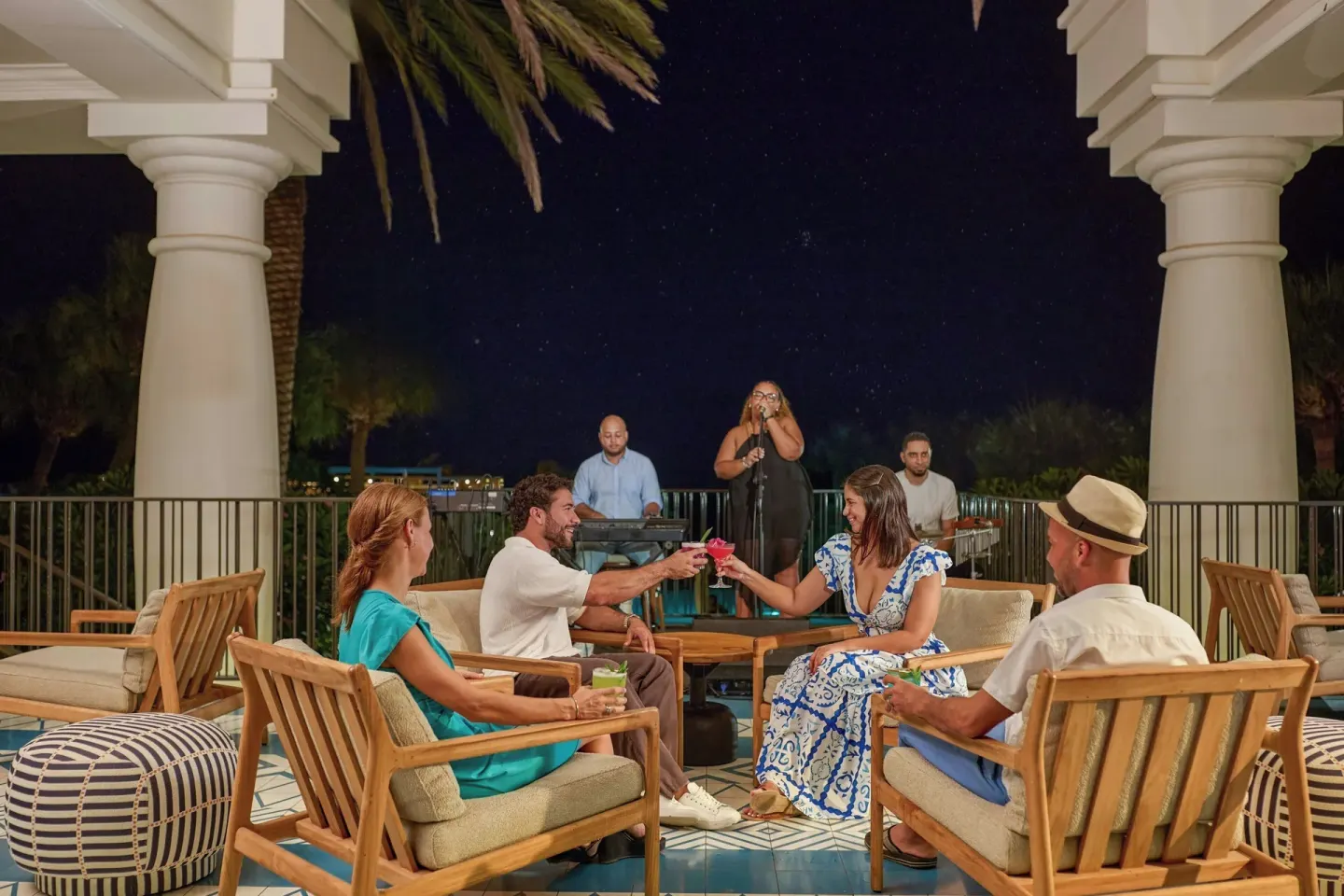 Guests enjoying drinks with live music at Curacao Marriott Beach Resort.