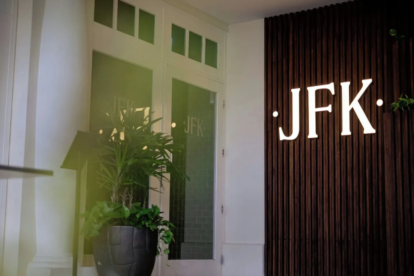 JFK entrance sign beside a potted plant at Curacao Marriott Beach Resort.