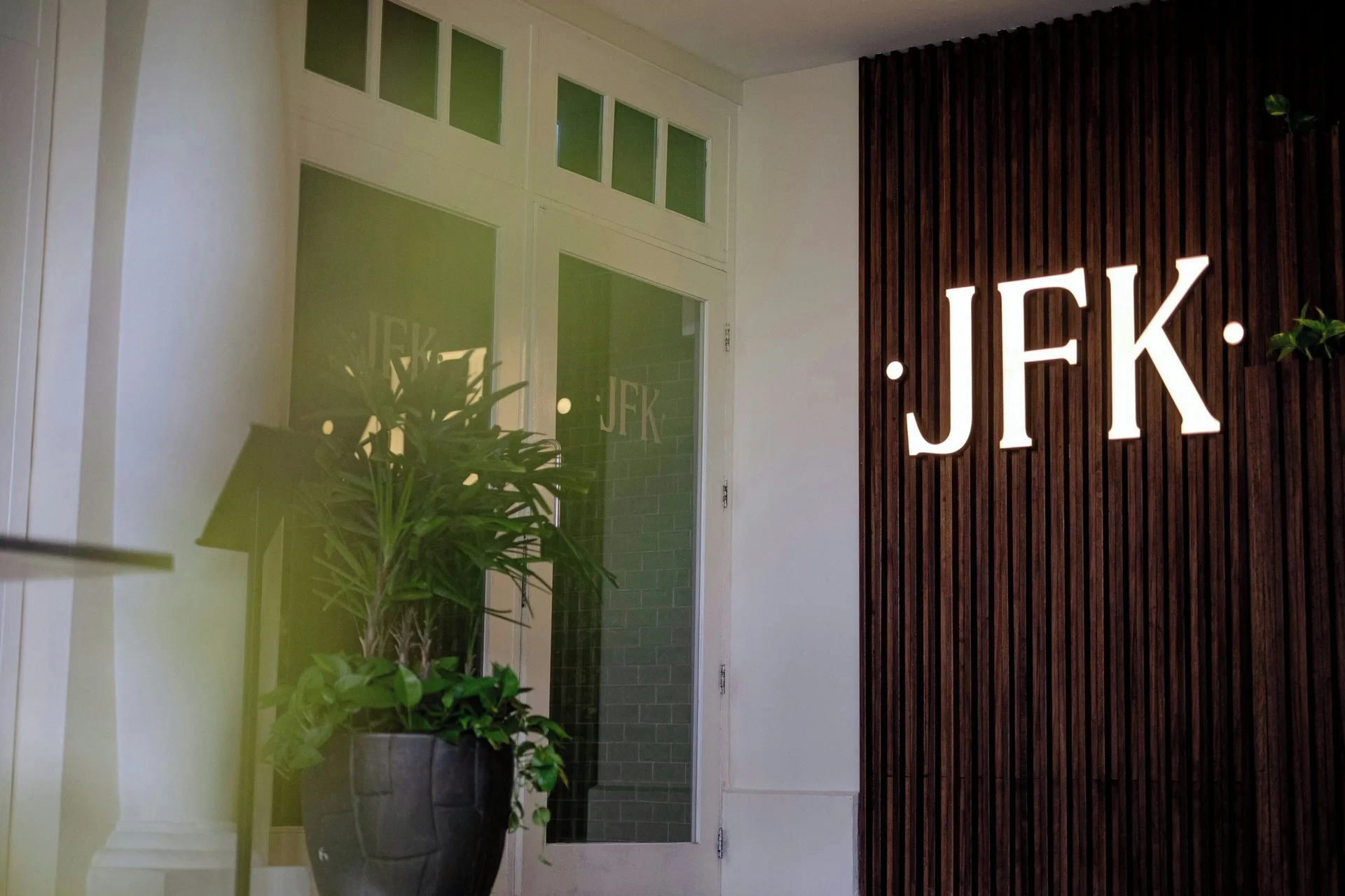 JFK entrance sign beside a potted plant at Curacao Marriott Beach Resort.