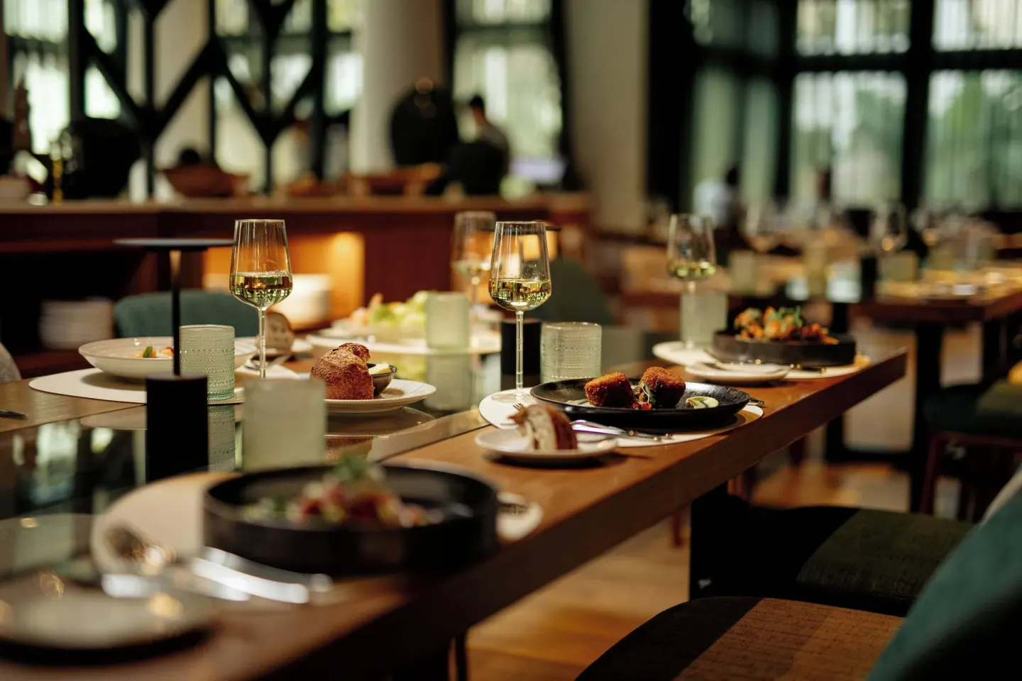 Set restaurant table with wine glasses and plated dishes at Curacao Marriott Beach Resort.