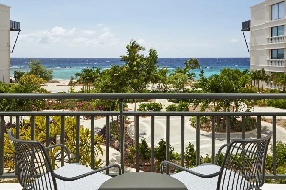 Balcony seating overlooks gardens and the ocean at Curacao Marriott Beach Resort.