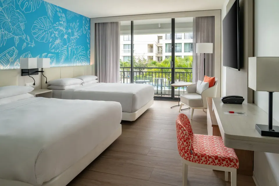 Double-bed guest room with balcony at Curacao Marriott Beach Resort.