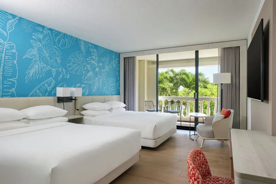 Two-bed room with balcony and garden view at Curacao Marriott Beach Resort.