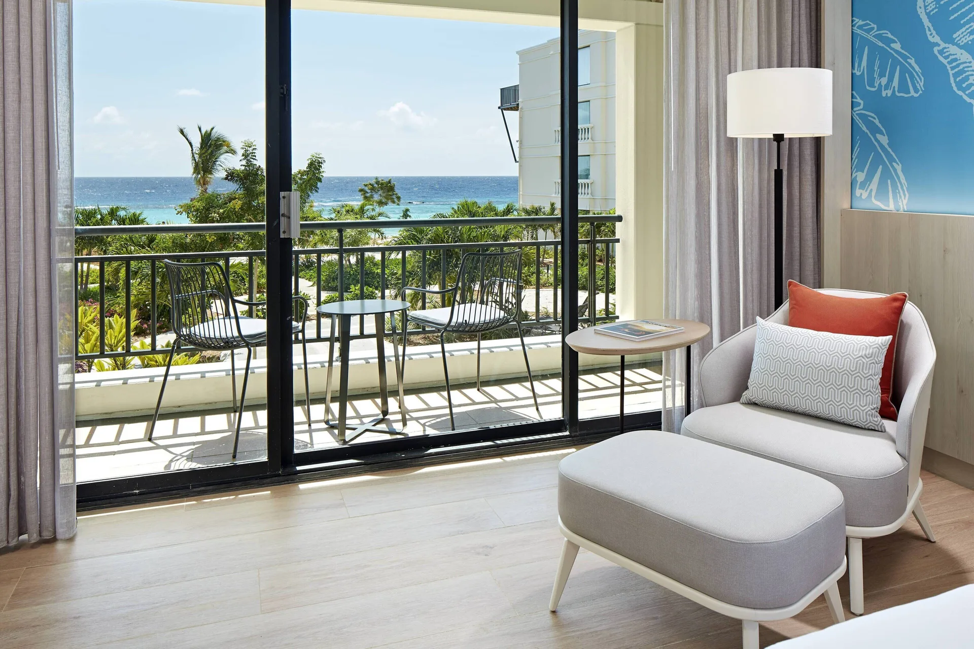 Guest room lounge chair and balcony ocean view at Curacao Marriott Beach Resort.