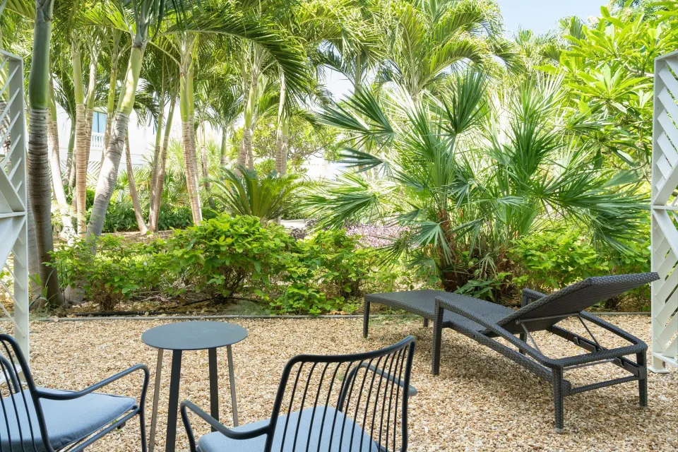 Garden patio with lounge chairs outside a room at Curacao Marriott Beach Resort.