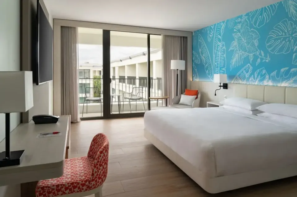 King bed room with desk, TV, and balcony doors at Curacao Marriott Beach Resort.