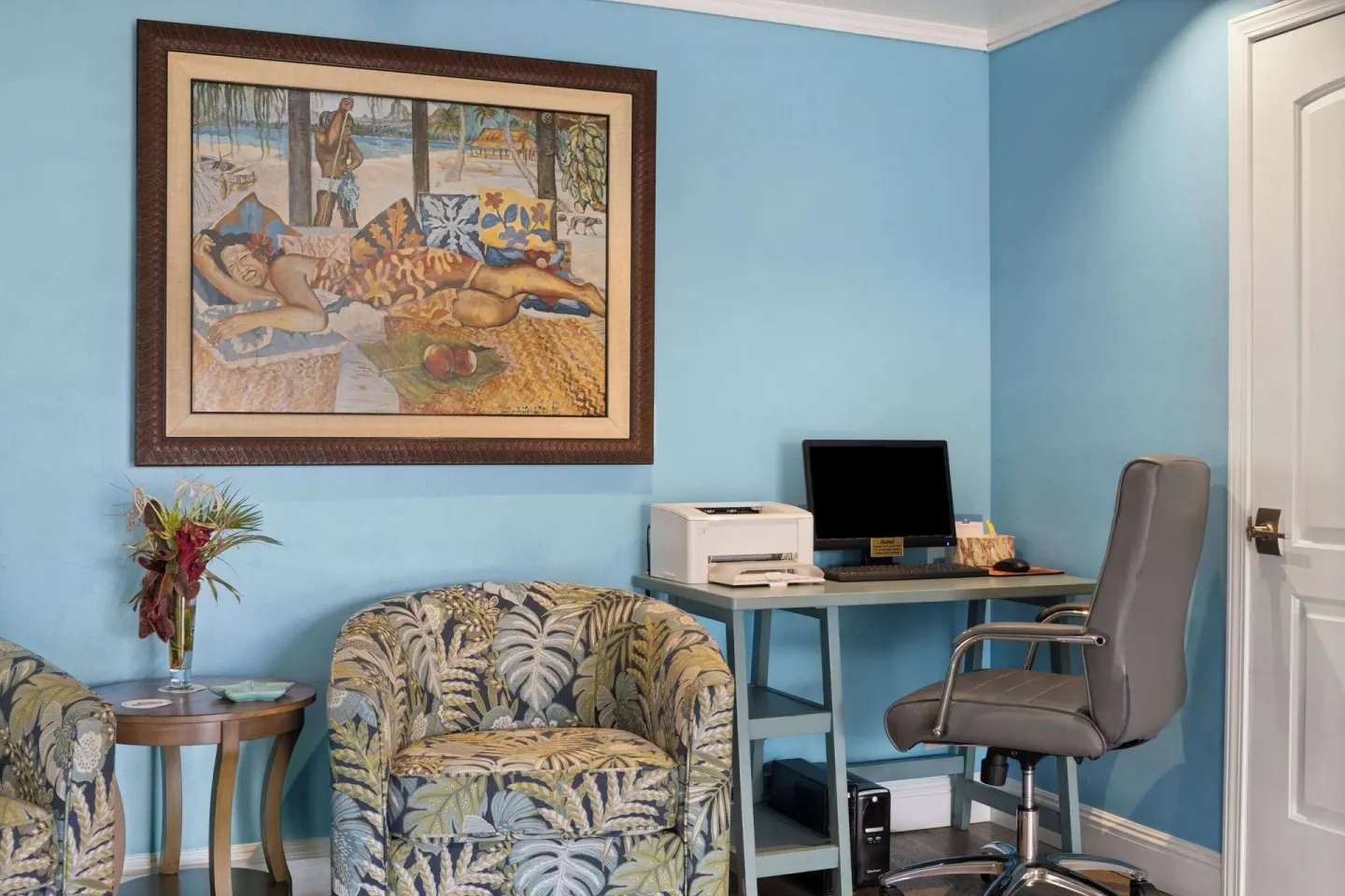 Business corner with desk, computer, printer, and lounge chair at Days Inn Maui Oceanfront.