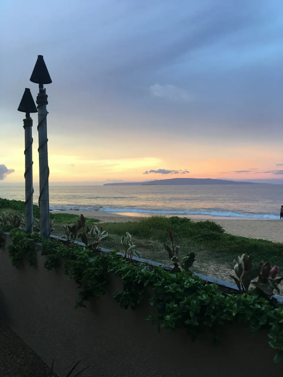 Ocean and beach at sunset viewed from near Days Inn Maui Oceanfront.