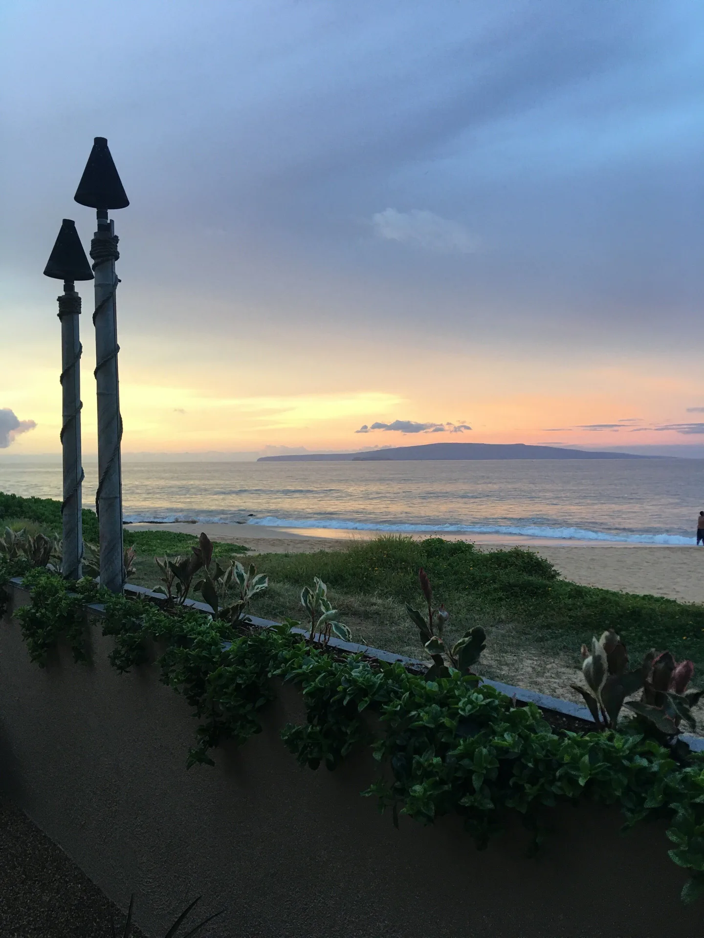 Ocean and beach at sunset viewed from near Days Inn Maui Oceanfront.