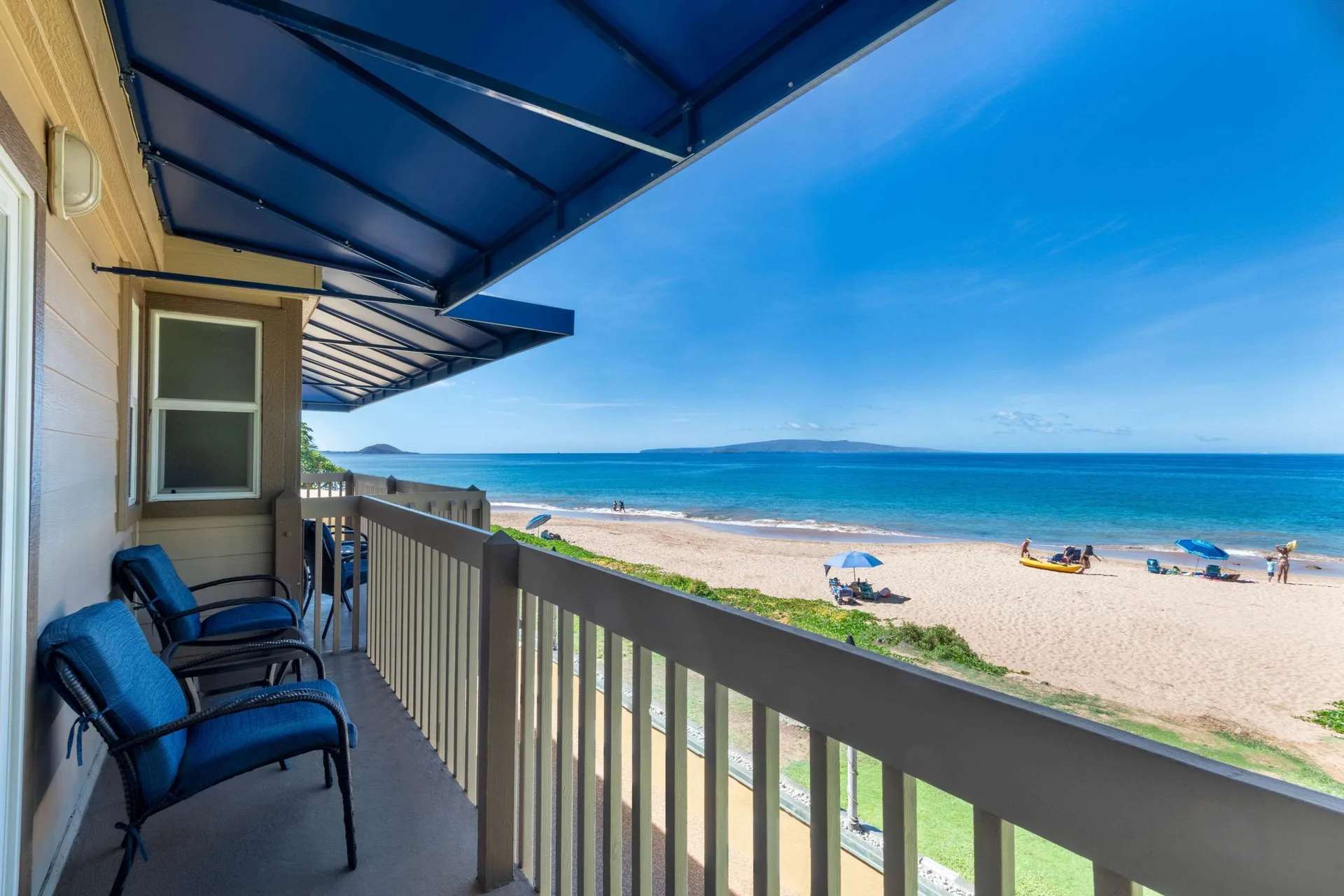 Ocean-view balcony at Days Inn Maui Oceanfront with chairs overlooking the beach and water.