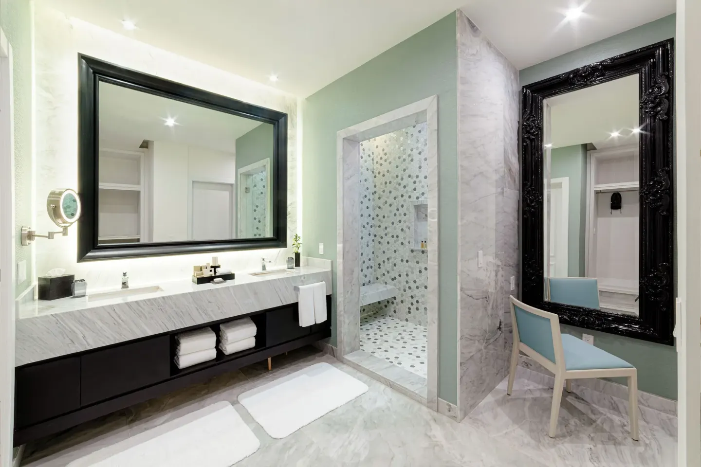 Spacious bathroom with double vanity and tiled shower at Desire Pearl Riviera Maya Resort.
