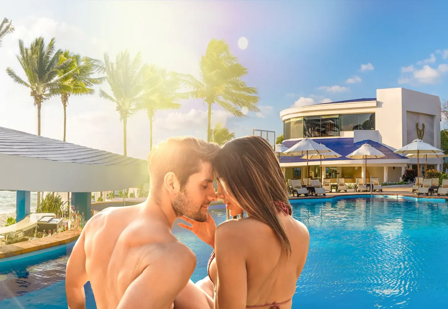 Couple sitting beside the pool in afternoon sun at Desire Pearl Riviera Maya Resort.