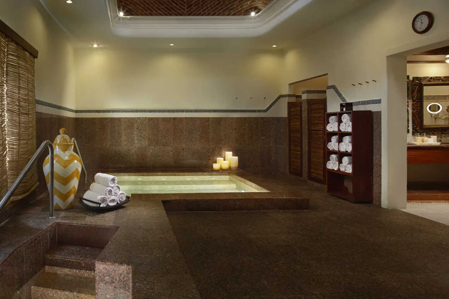 Spa hydrotherapy pool with towels and candles at Desire Pearl Riviera Maya Resort.
