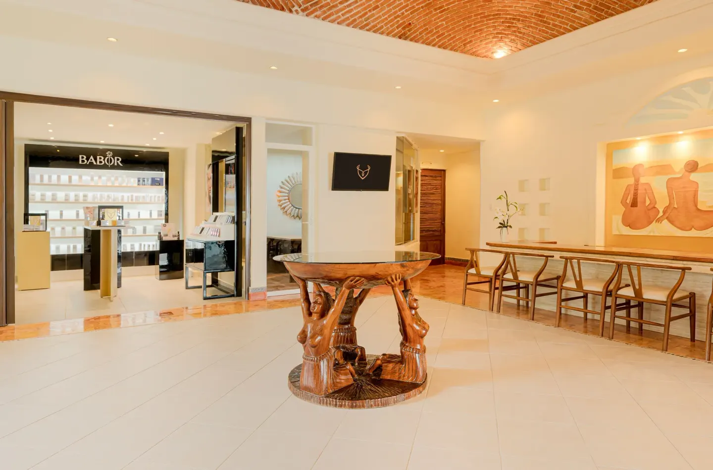 Spa lobby with display boutique and carved table at Desire Pearl Riviera Maya Resort.