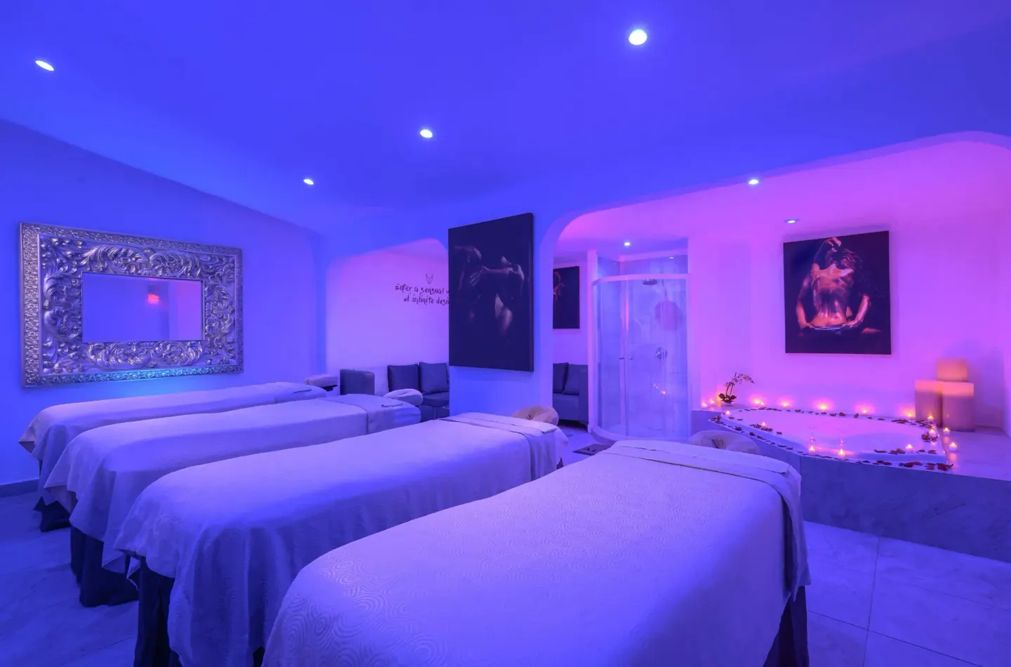 Spa room with multiple massage beds and candlelit tub at Desire Pearl Riviera Maya Resort.