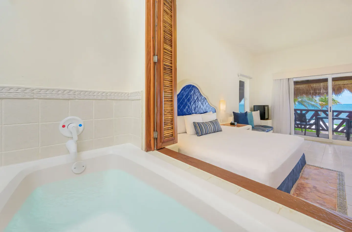 Junior Suite bath opening to a king bedroom at Desire Pearl Riviera Maya Resort.