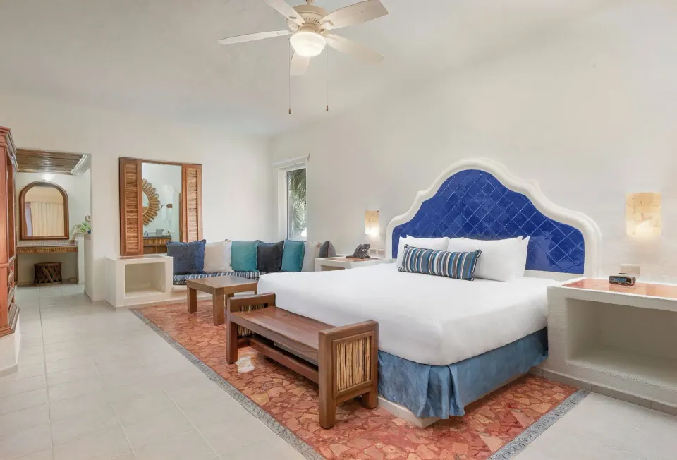Master Suite with Plunge Pool king bed and sitting area at Desire Pearl Riviera Maya Resort.