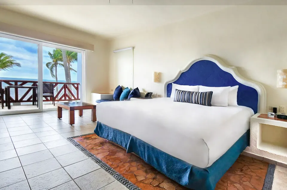 Master Suite king bed and ocean-facing balcony at Desire Pearl Riviera Maya Resort.