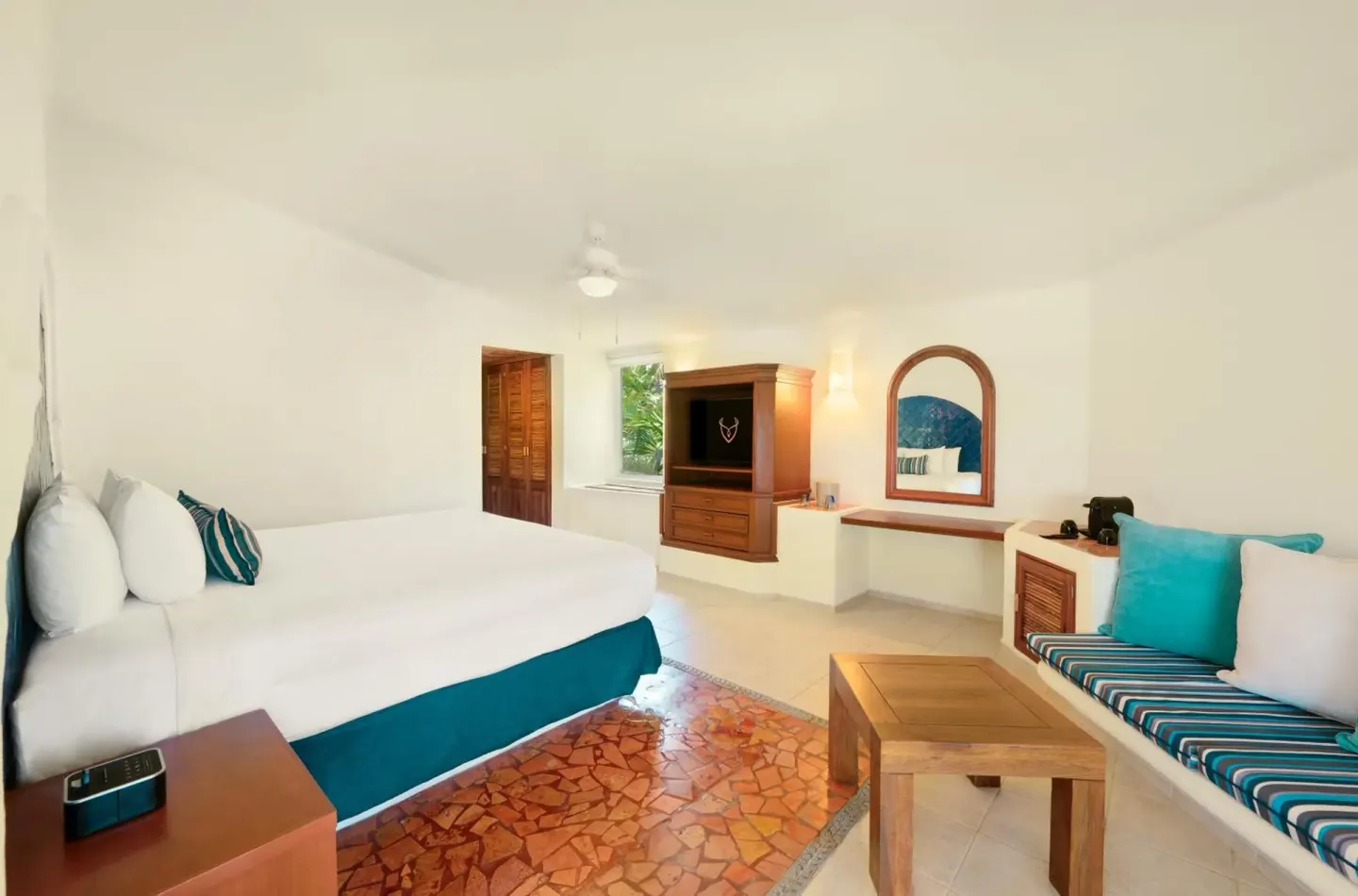 Ocean View Room king bed, sofa, TV cabinet, and vanity at Desire Pearl Riviera Maya Resort.