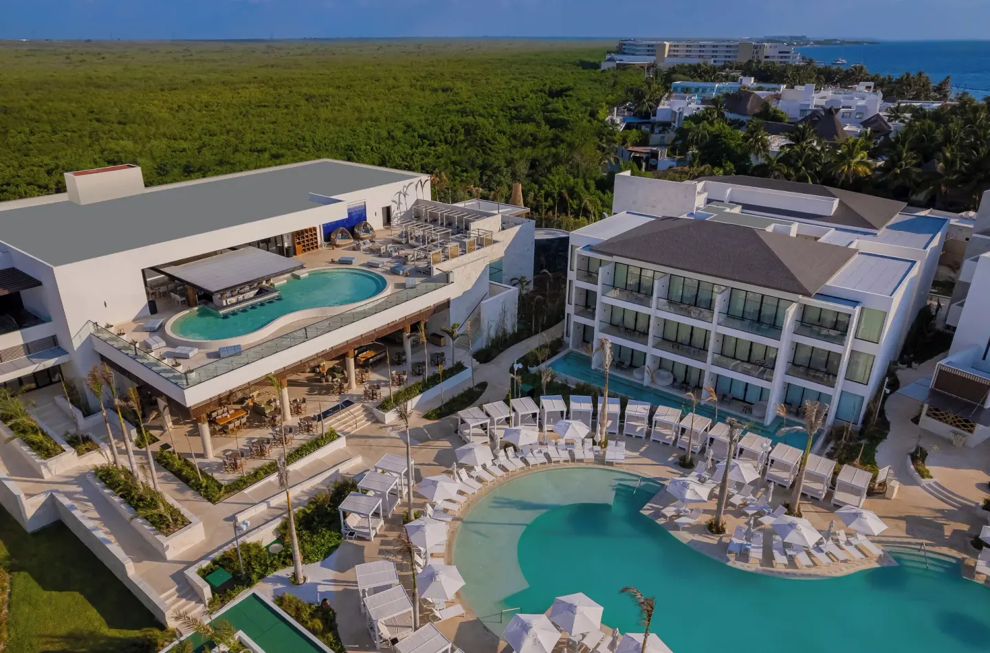 Aerial view of pools, cabanas and rooftop water features at Desire Riviera Maya Resort.