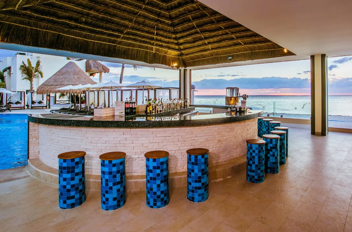 Beachside bar with ocean view at Desire Riviera Maya Resort.
