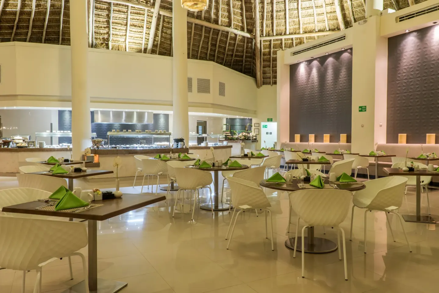 Buffet dining room with thatched ceiling at Desire Riviera Maya Resort.