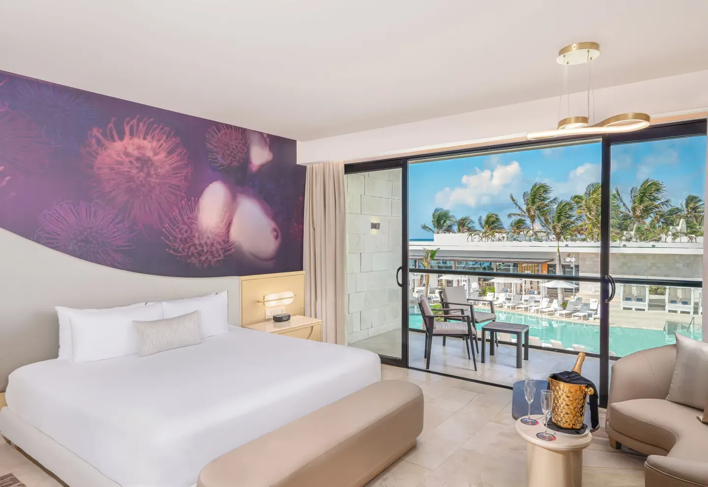 Beloved Pool-View Jacuzzi Suite bedroom and balcony at Desire Riviera Maya Resort