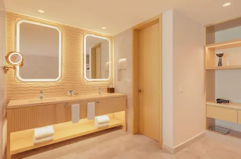 Beloved Tropical-View Jacuzzi Suite bathroom vanity with double sinks at Desire Riviera Maya Resort.