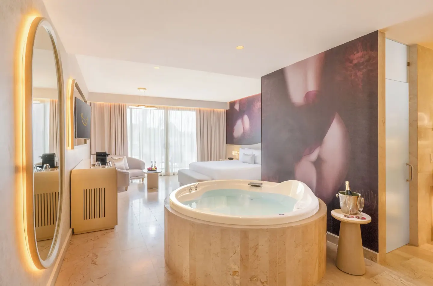 Beloved Tropical-View Jacuzzi Suite with indoor tub, king bed, and illuminated mirror at Desire Riviera Maya Resort.
