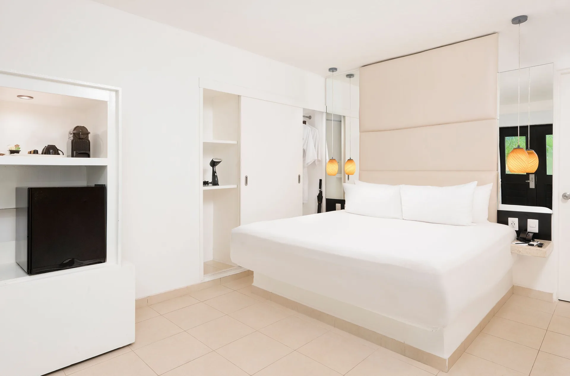 Deluxe Garden View Room with king bed, shelving, and pendant lights at Desire Riviera Maya Resort.