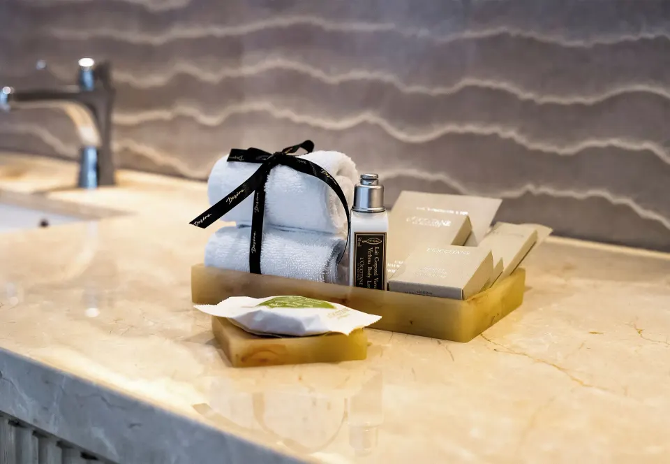 Bathroom vanity amenities and folded towels at Desire Riviera Maya Resort.