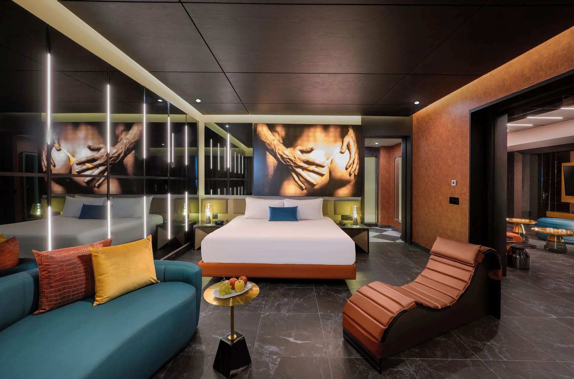 Diamond Ocean View Jacuzzi Suite king bed and lounge at Desire Riviera Maya Resort.